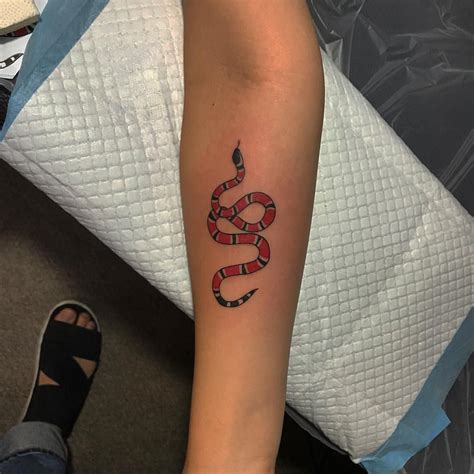 gucci snake bicep tattoo